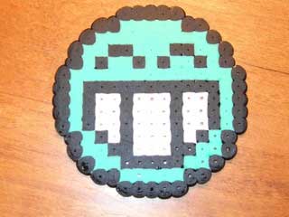 A laughing emoticon, made with “Perler Beads”.