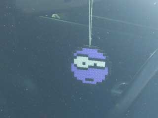 A raised-eyebrow emoticon, made with “Perler Beads”.