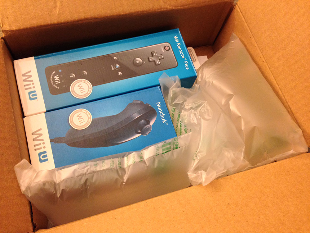 The “Nintendo Wii Nunchuck Controller” and “Wii Remote Plus” arriving in a box from Amazon Prime.