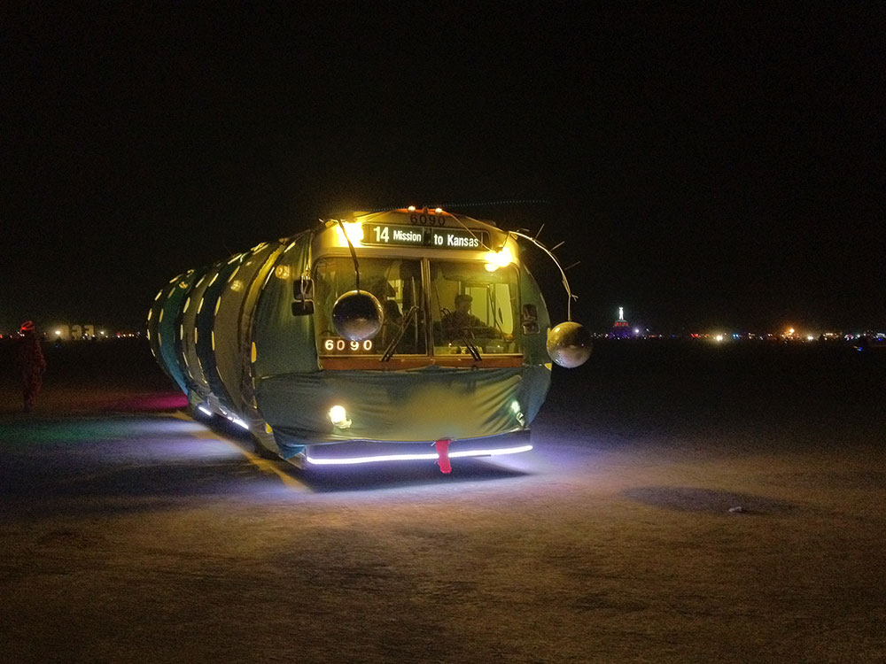 A decommissioned San Francisco bus offering transportation across the playa at Burning Man.